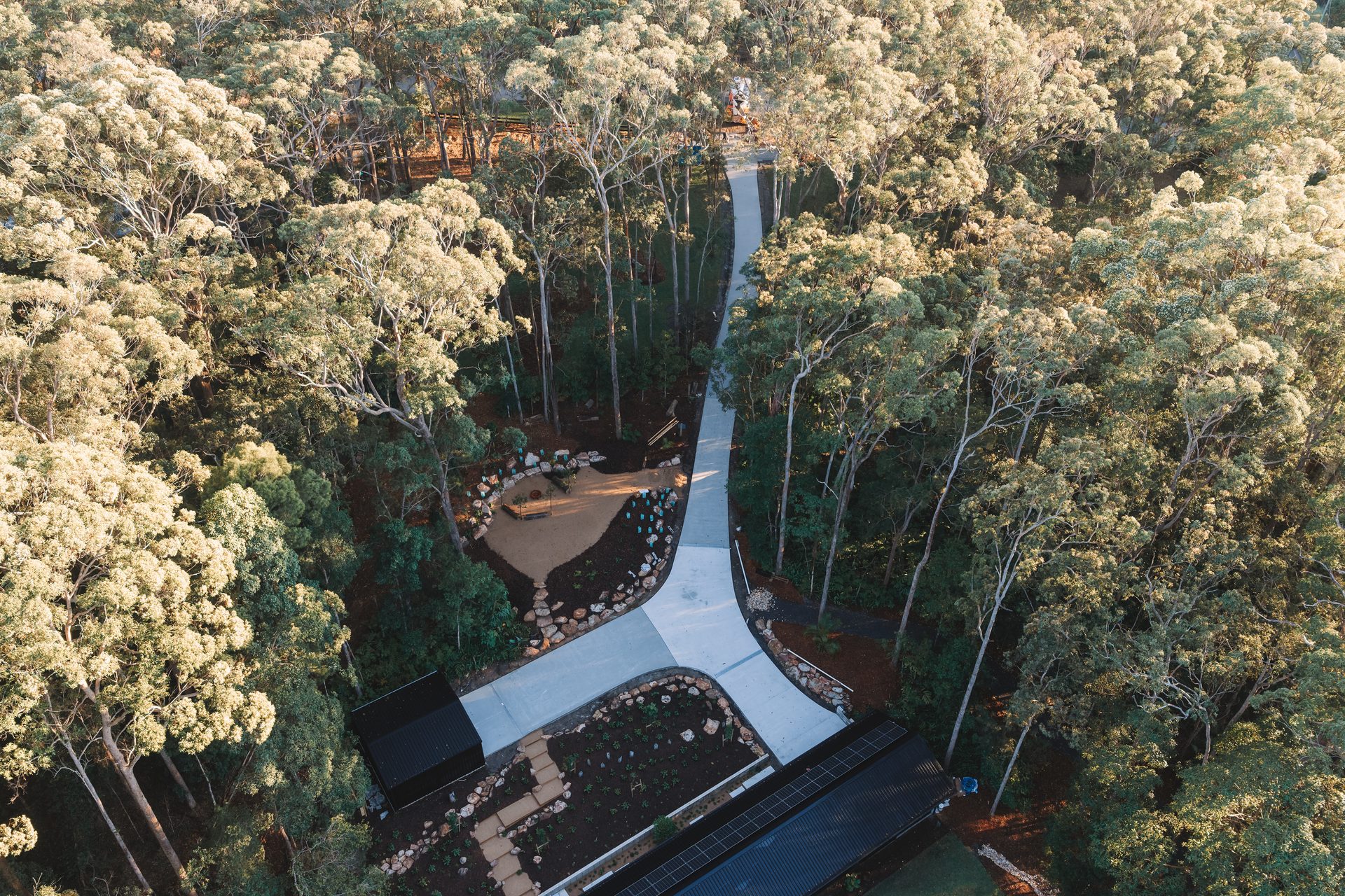 Aerial view of a finished concrete driveway curving through Sunshine Coast bushland