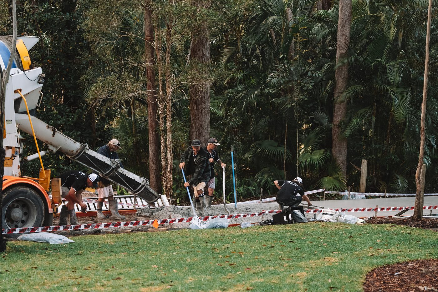 Crew placing concrete with the truck alongside the run