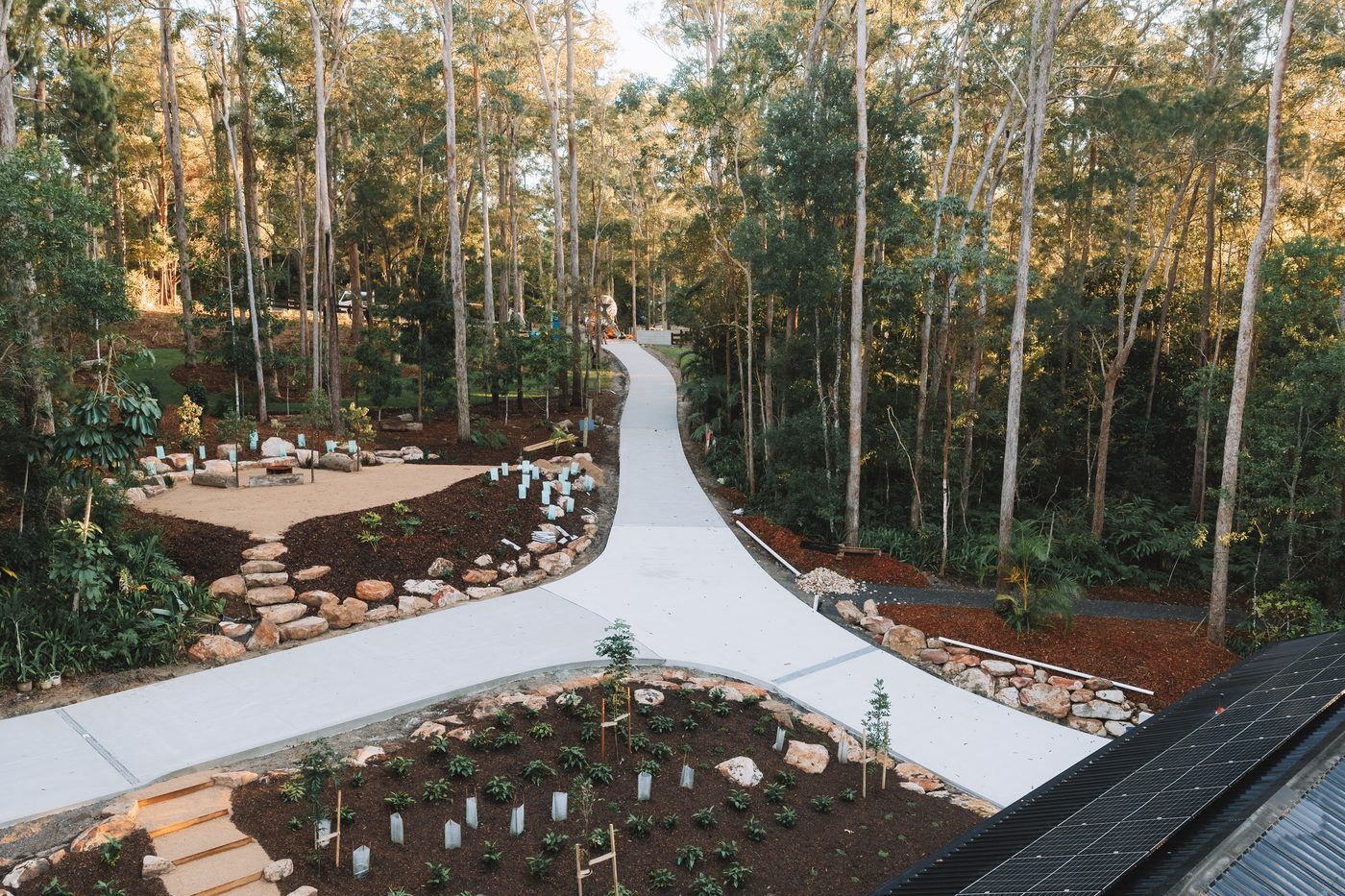Aerial view of a finished driveway curving through bushland
