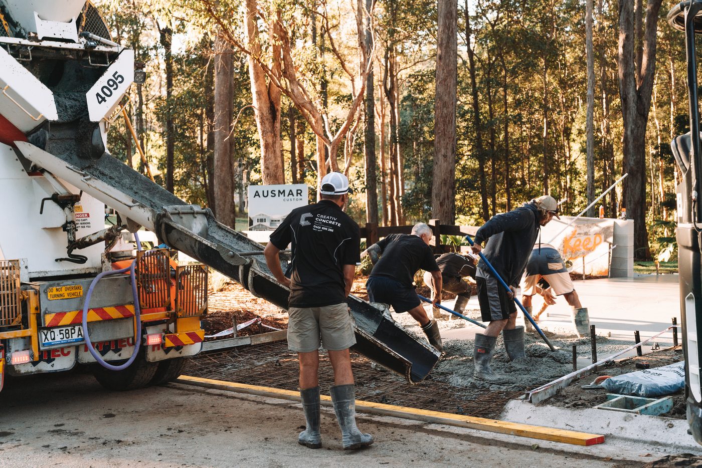 Concrete truck and crew mid-pour on a new build