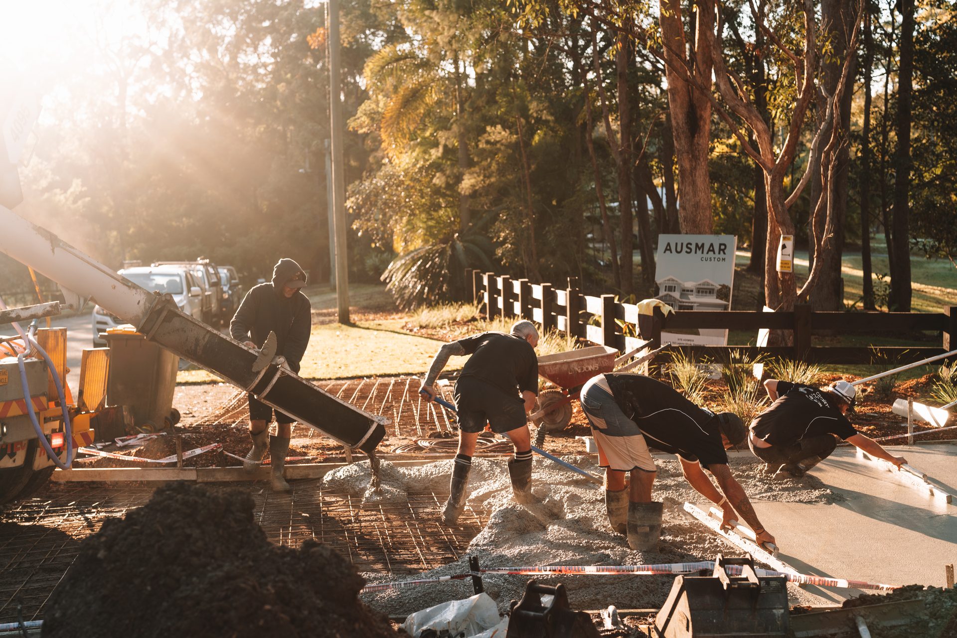 Creativ Concrete crew screeding a house slab at golden hour