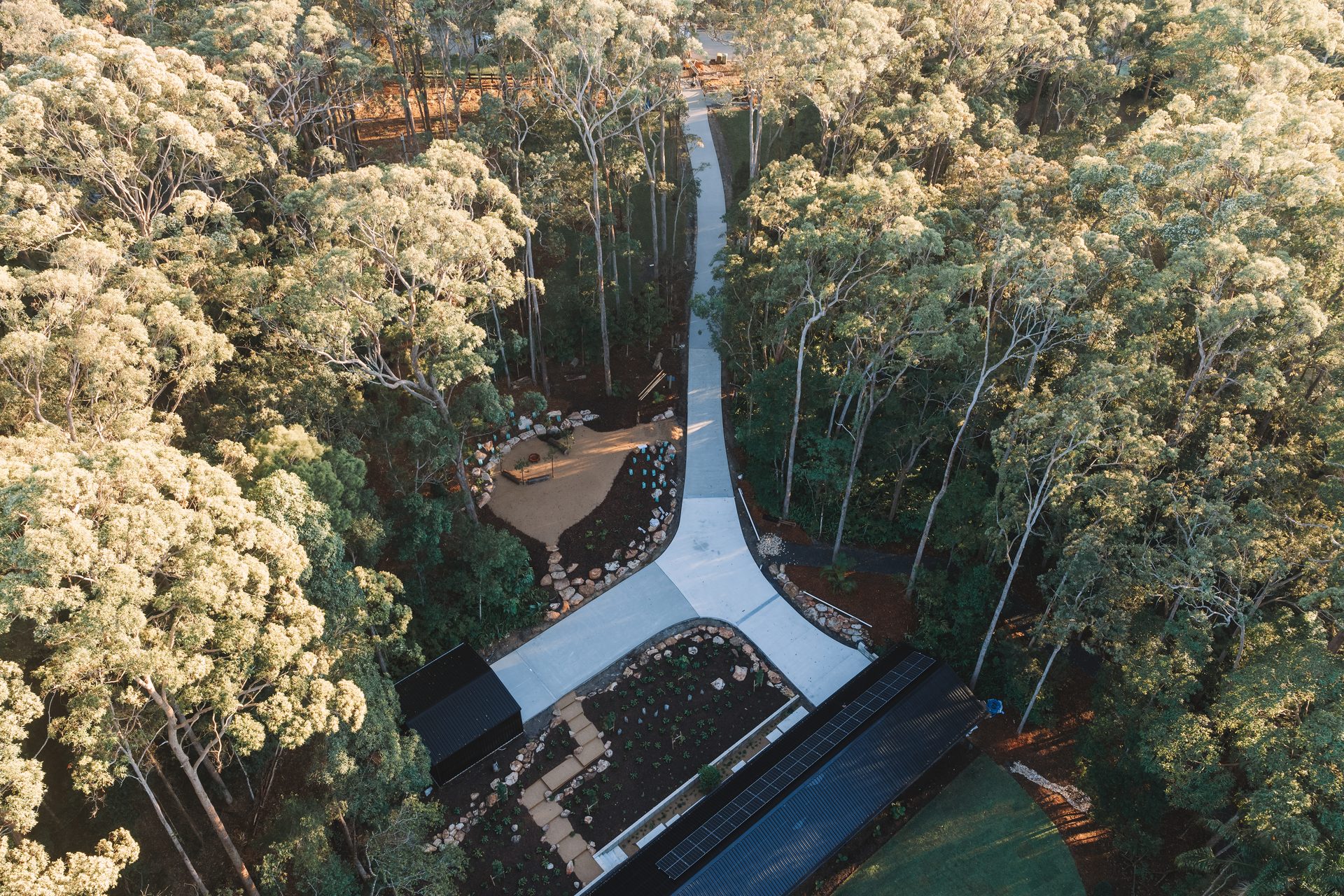 Aerial view of a curved concrete driveway through Sunshine Coast bushland