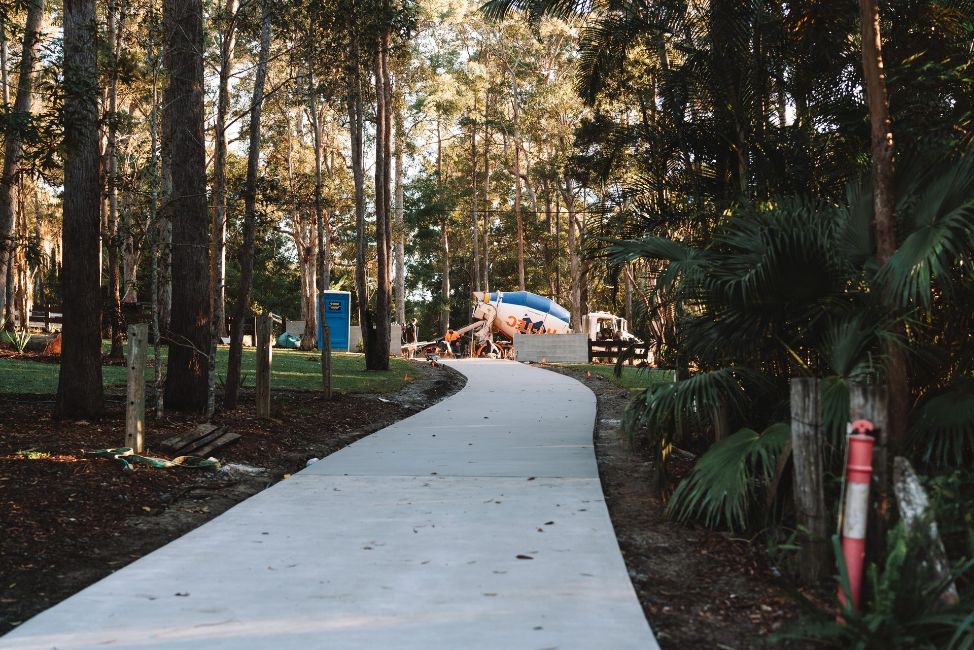 Finished concrete driveway sweeping through native trees