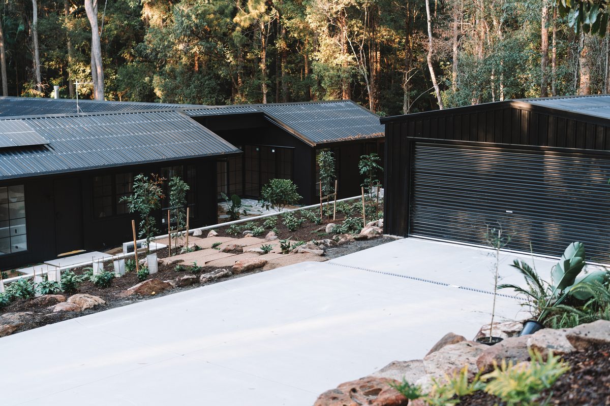 Wide concrete driveway finished alongside a new custom home