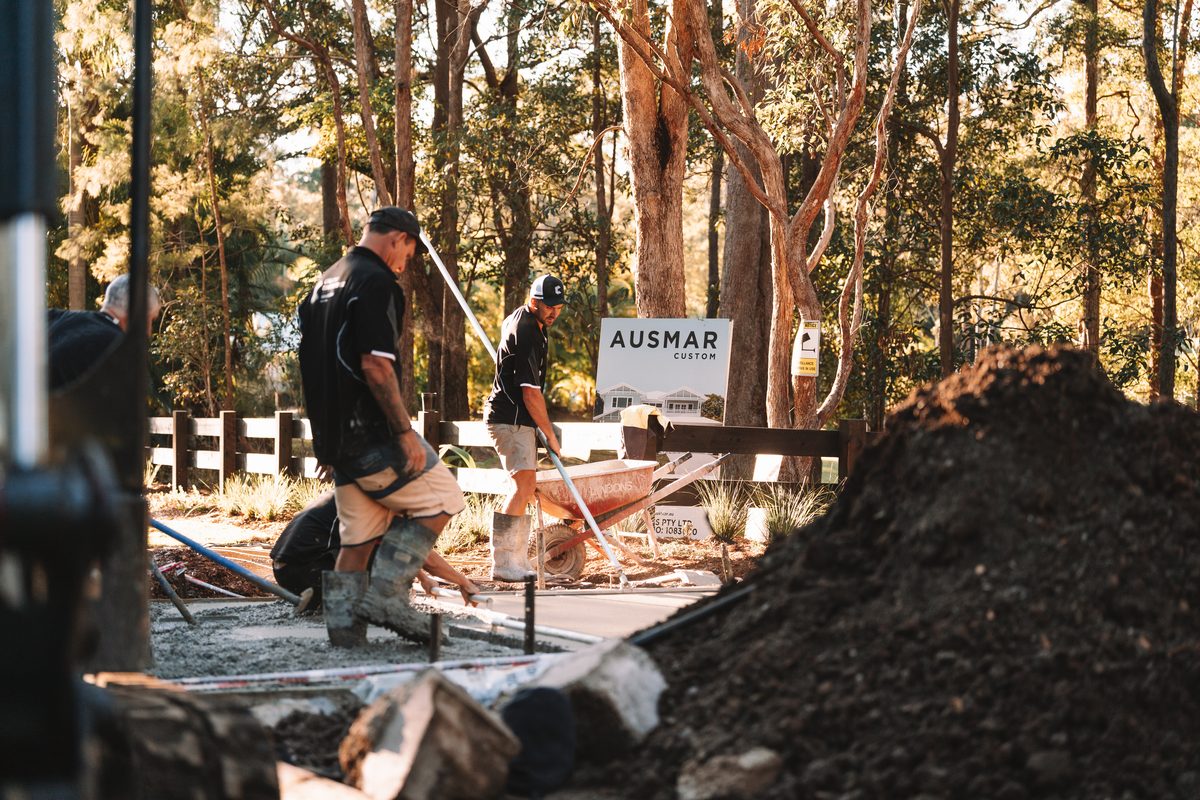 Working the slab beside the builder&rsquo;s site sign